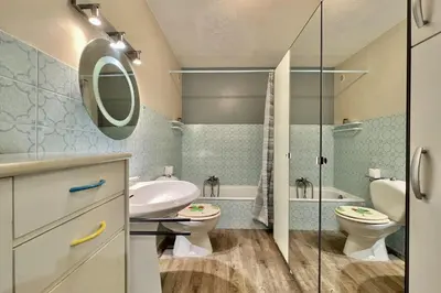 a bathroom with a sink and a toilet and a shower at Bright studio just outside Cannes in Le Cannet
