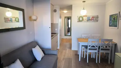 a living room with a couch and a table at Résidence Pierre et Vacance 631 in Cannes