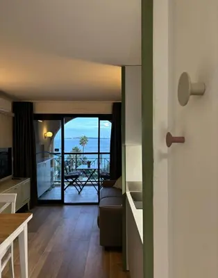 a living room with a view of the ocean at Résidence Pierre et Vacance 631 in Cannes