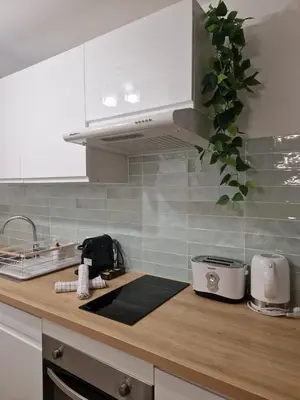 a kitchen with white cabinets and a counter top at Studio cosy près de la Croisette in Cannes