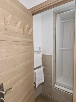 a bathroom with a glass shower door with towels at Studio cosy près de la Croisette in Cannes