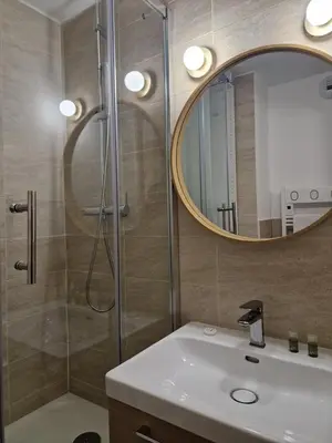 a bathroom with a shower and a sink and a mirror at Studio cosy près de la Croisette in Cannes