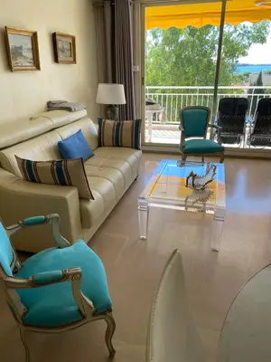 a living room with a couch and two chairs at Les Pervenches in Cannes