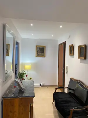 a living room with a couch and a table at Les Pervenches in Cannes