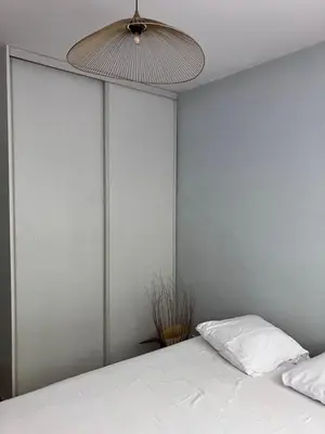 a bedroom with a bed and a ceiling fan at Rez de Jardin Paisible avec Parking - Entrée des Artistes in Cannes