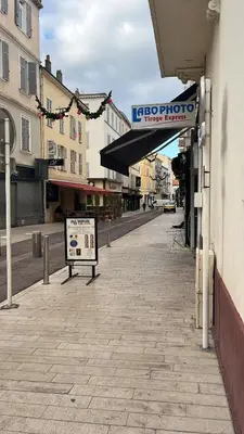 a sign for a store on a city street at Studio au cœur de Cannes in Cannes