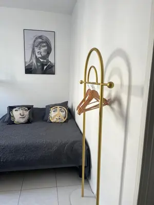 a bedroom with a bed and a framed picture at Studio au cœur de Cannes in Cannes