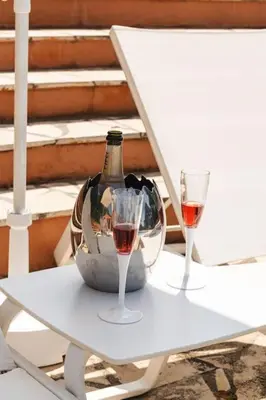 a white table with two glasses of wine on it at Dream Villa 300m2 & stunning 4000m2 private garden in Cannes