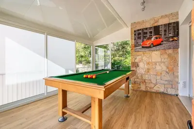 a pool table in a room with a car on the wall at Dream Villa 300m2 & stunning 4000m2 private garden in Cannes