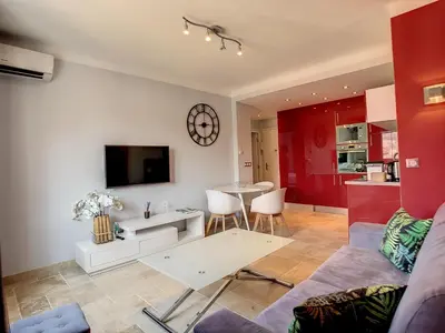 a living room with a couch and a table at 1 bedroom rue d'Antibes , 1 min from the Croisette, 5 mins from the Palais 202 in Cannes