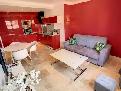 a living room with a couch and a table at 1 bedroom rue d'Antibes , 1 min from the Croisette, 5 mins from the Palais 202 in Cannes