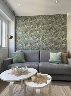 a living room with a couch and a table at Superbe 2 pièces, tout équipé centre de Cannes. in Cannes