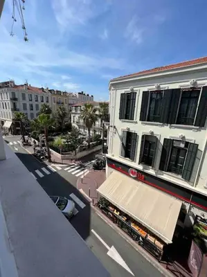 a building with a awning on the side of a street at Superbe 2 pièces, tout équipé centre de Cannes. in Cannes