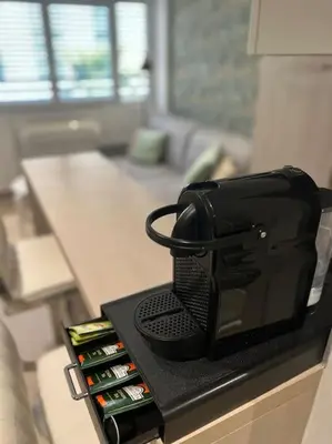 a black counter top with bottles of wine at Superbe 2 pièces, tout équipé centre de Cannes. in Cannes
