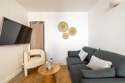 a living room with a blue couch and a chair at Beautiful 1BR, heart of Suquet-Cannes - 5min beach in Cannes
