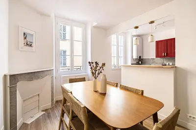 a kitchen and dining room with a wooden table and chairs at Beautiful 1BR, heart of Suquet-Cannes - 5min beach in Cannes