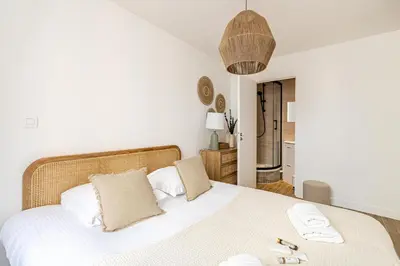 a bedroom with a white bed with two towels on it at Beautiful 1BR, heart of Suquet-Cannes - 5min beach in Cannes