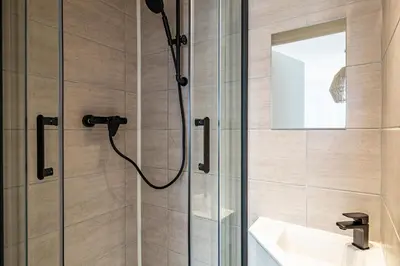 a bathroom with a shower with a sink and a mirror at Beautiful 1BR, heart of Suquet-Cannes - 5min beach in Cannes