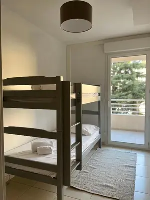 two bunk beds in a room with a window at Alice in Cannes