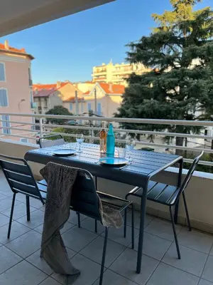 a blue table and chairs on a balcony at Alice in Cannes