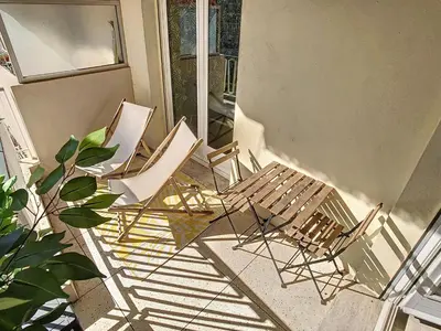 a group of chairs sitting on a porch at 1 bedroom Velasquez, 5 mins from Croisette 244 Cannes Riviera in Cannes