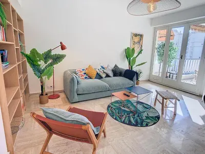 a living room with a couch and a table at 1 bedroom Velasquez, 5 mins from Croisette 244 Cannes Riviera in Cannes