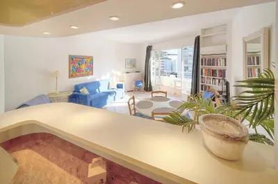 a living room with a table and a plant at FRGK 