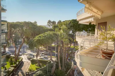 a balcony of a building with trees and a street at FRGK 