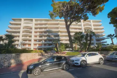 two cars parked in a parking lot in front of a building at FRGK 