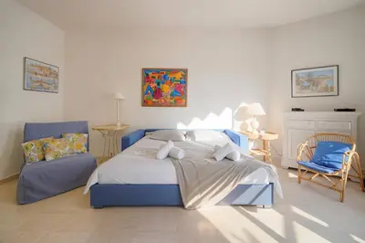 a bedroom with a blue bed and a chair at FRGK 