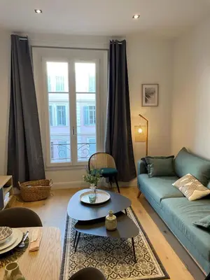 a living room with a couch and a table at Le Borniol by Connexion in Cannes
