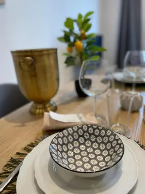 a black and white plate on a wooden table at Le Borniol by Connexion in Cannes