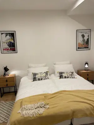 a bedroom with a large white bed with two night stands at Le Borniol by Connexion in Cannes