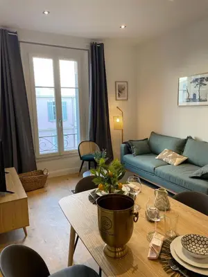 a living room with a couch and a table at Le Borniol by Connexion in Cannes