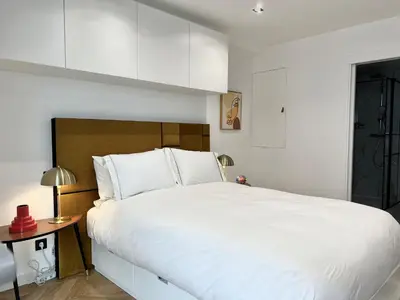 a bedroom with a large white bed and a table at Moderne Studio BALCON, rue D'ANTIBES- HYPER CENTRE A0B191 in Cannes