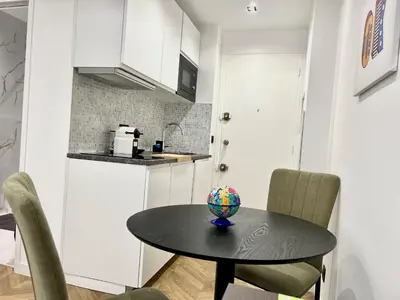 a kitchen with a table with a ball on it at Moderne Studio BALCON, rue D'ANTIBES- HYPER CENTRE A0B191 in Cannes