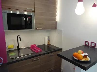 a kitchen with a plate of fruit on a counter at Superbe Studio in Cannes 450m sea & parking in Cannes