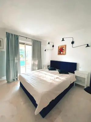 a bedroom with a large bed and a window at 2 bedroom apartament close to the beach in Cannes