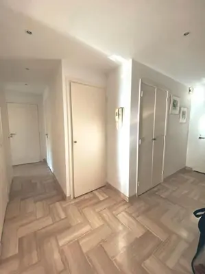 an empty room with wooden floors and white walls at 2 bedroom apartament close to the beach in Cannes