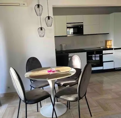 a table and chairs in a room with a kitchen at 2 bedroom apartament close to the beach in Cannes