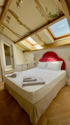a bedroom with a large bed with a red headboard at L'échelle Rouge in Cannes