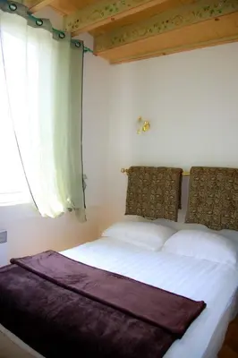 a bedroom with a large bed with a window at L'échelle Rouge in Cannes