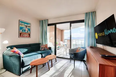 a living room with a couch and a tv at Résidence Cannes Verrerie - maeva Home - Appartement climatisé 3 pièces 4 personnes - Budget MAE-6894 in Cannes