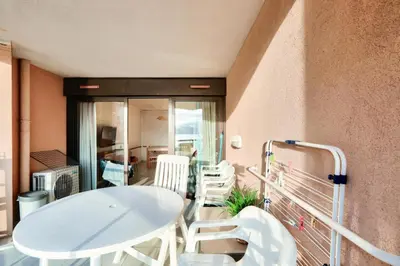 a balcony with a white table and white chairs at Résidence Cannes Verrerie - maeva Home - Appartement climatisé 3 pièces 4 personnes - Budget MAE-6894 in Cannes
