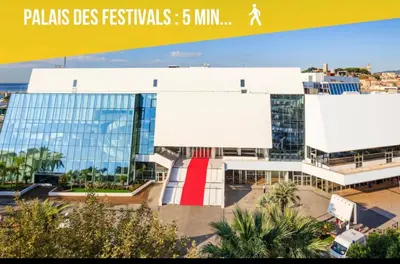 a large building with a red door in front of it at TOP Choice Dispo Cannes Croisette Hotel Majestic Plages 1mn Palais 5mn in Le Cannet