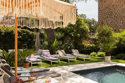 a backyard with chairs and a swimming pool with a chandelier at Luxueuse Villa 7 chambres avec piscine - Cannes in Cannes