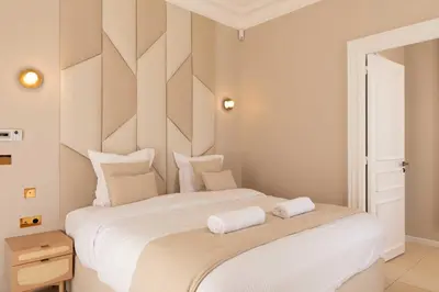 a bedroom with a large white bed with two towels on it at Luxueuse Villa 7 chambres avec piscine - Cannes in Cannes