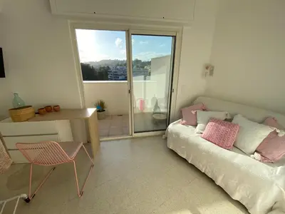 a bedroom with a bed and a desk and a window at Vue mer à couper le souffle - nouveau entièrement rénové in Cannes