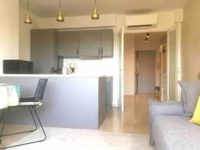 a living room with a couch and a kitchen at 2 bedroom apartment in Cannes near the beach in Cannes