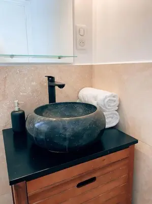 a bathroom with a sink on a black counter at 2 bedroom apartment in Cannes near the beach in Cannes